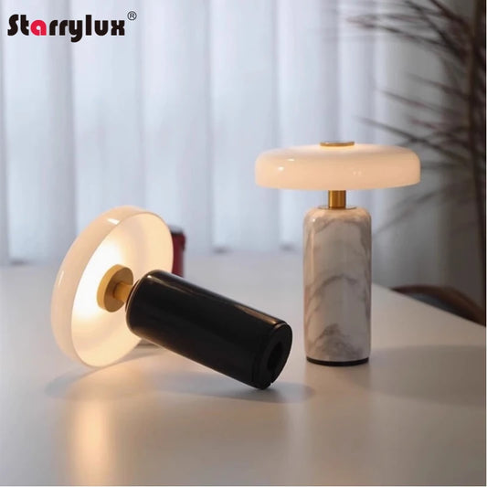 Marble cordless table lamp with a linen shade, lit on a side table
